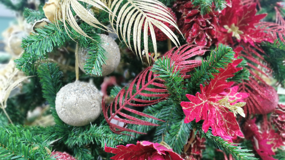 holiday greenery with red accents and white ornaments