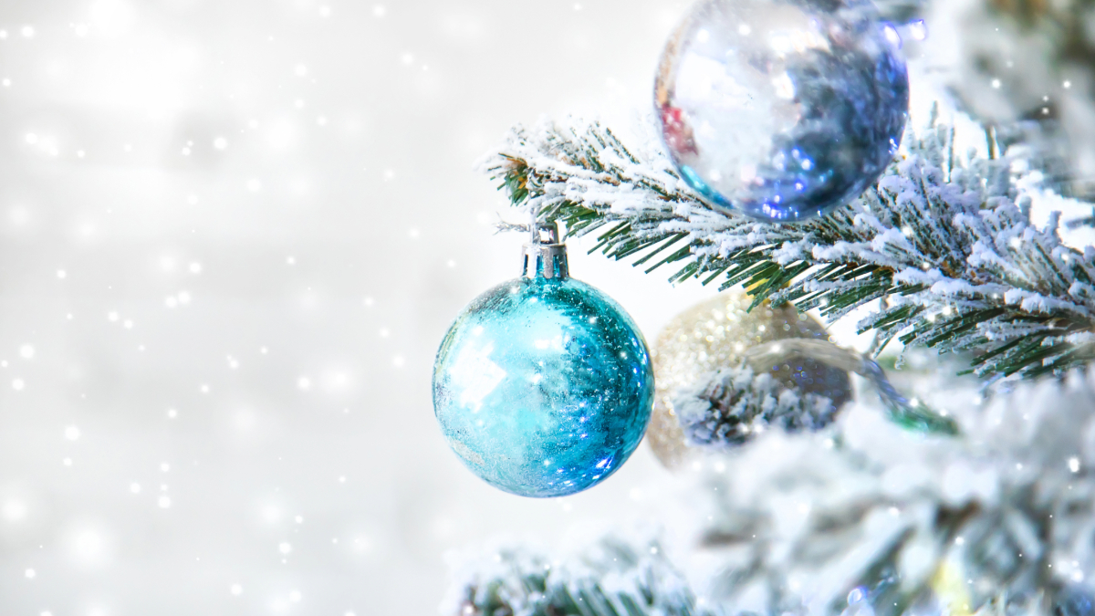 grey background with snowy tree and blue ornament