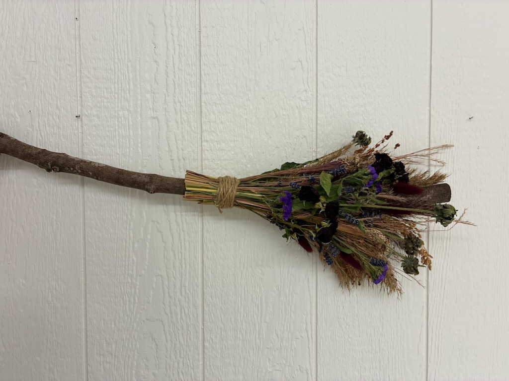 Handmade broom with dried flowers.