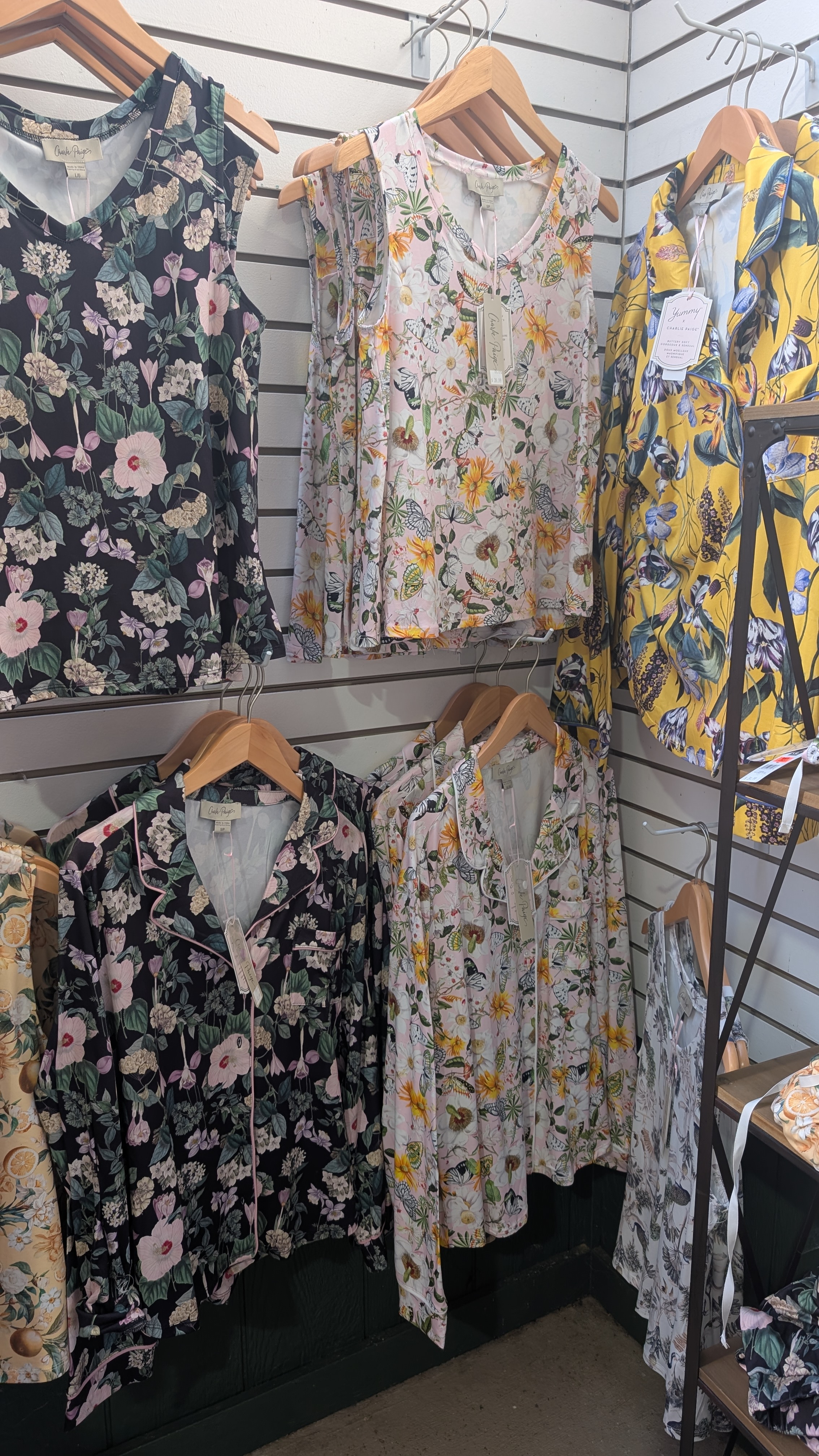 Wall with pajama tops on hangers.