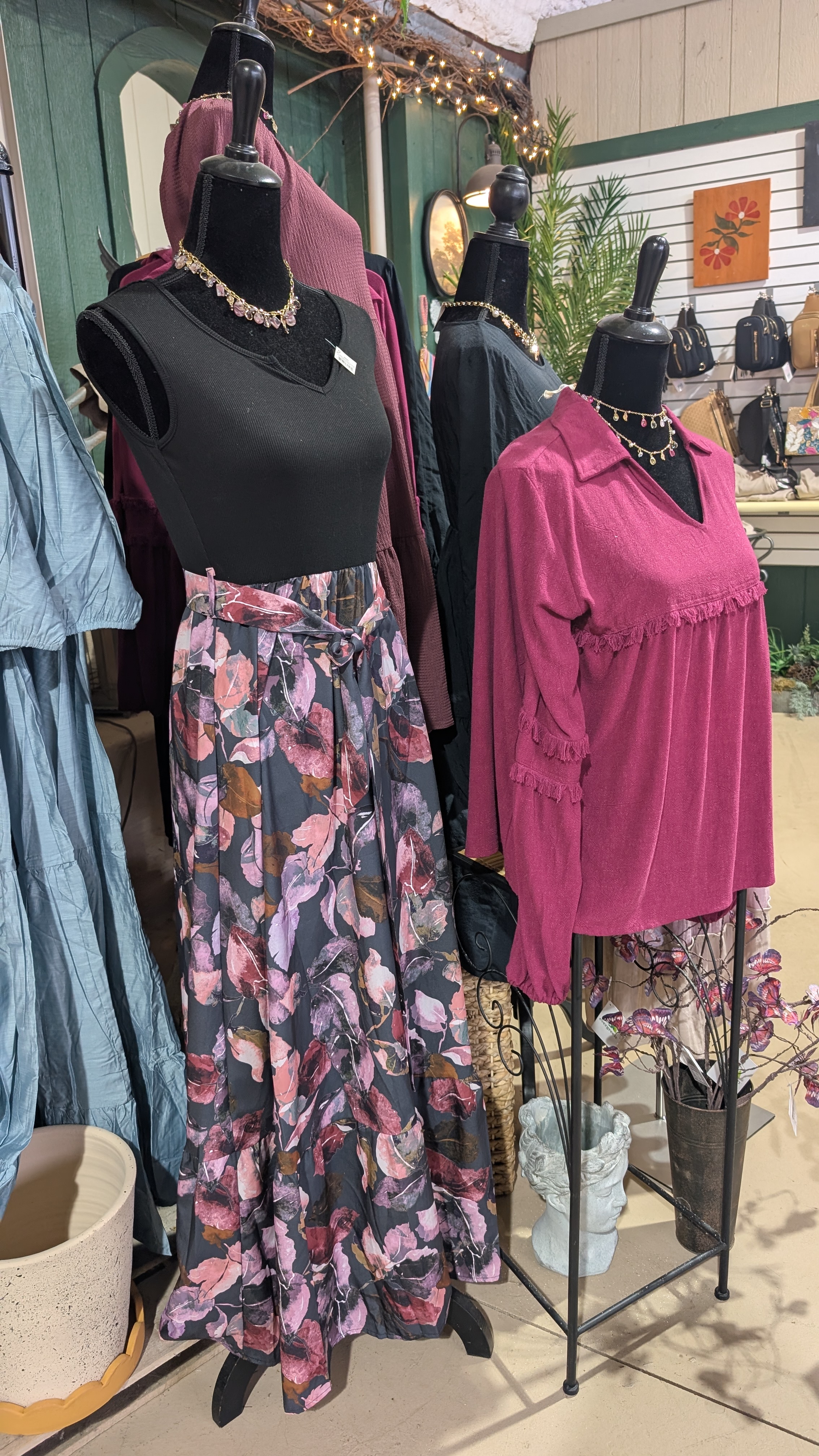 Full manequin with a dress with a flower skirt and black top.