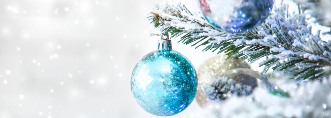 grey background with snowy tree and blue ornament